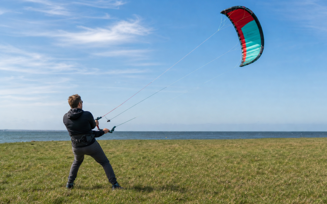 Fortgeschrittener Pilot steuert eine Vierleiner-Powerkite-Matte mit Handles auf freier Küstenwiese